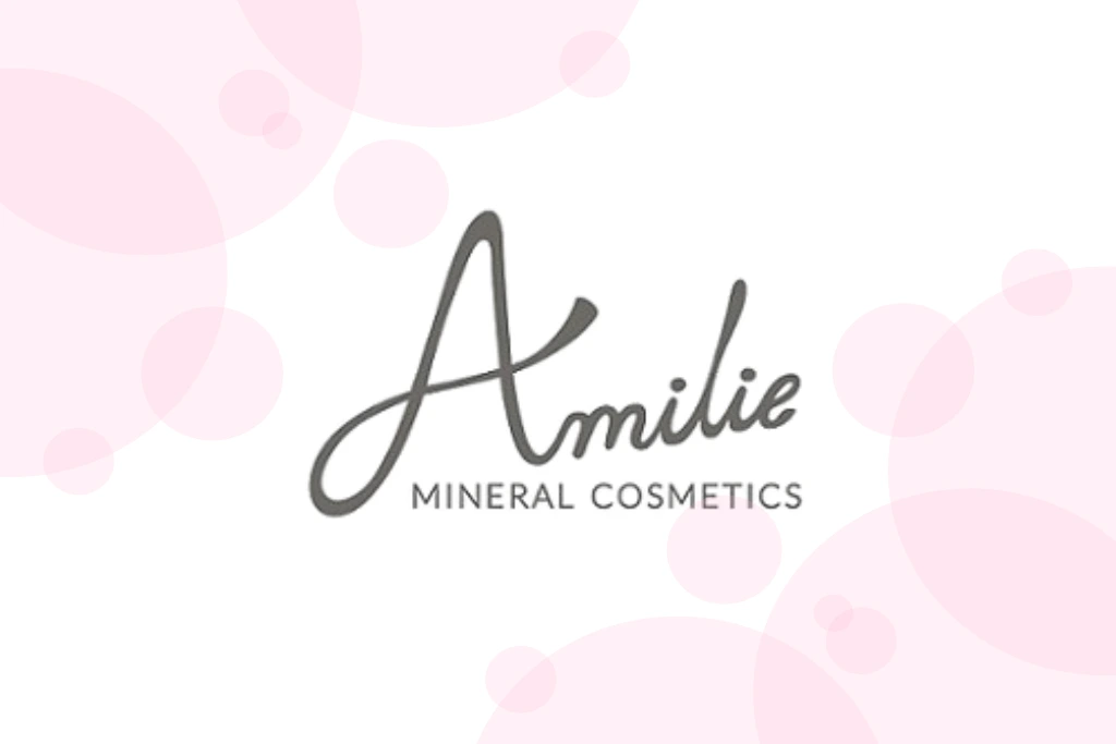 Logo "Amilie" w pisanym kroju z napisem "MINERAL COSMETICS" na białym tle, różowe bąbelki.